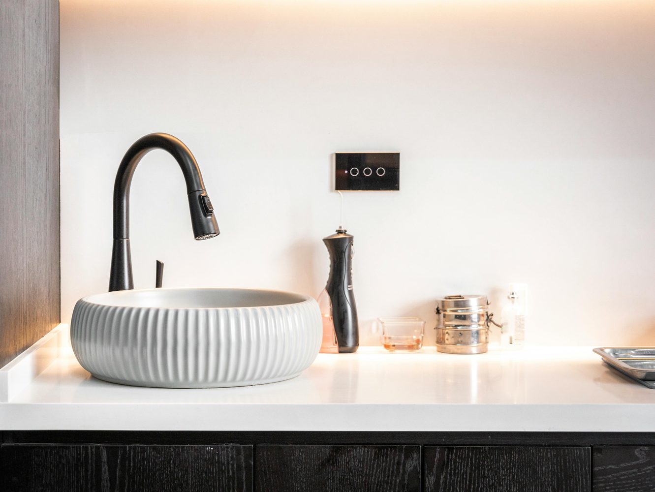 Modern sink and faucet on a bright countertop